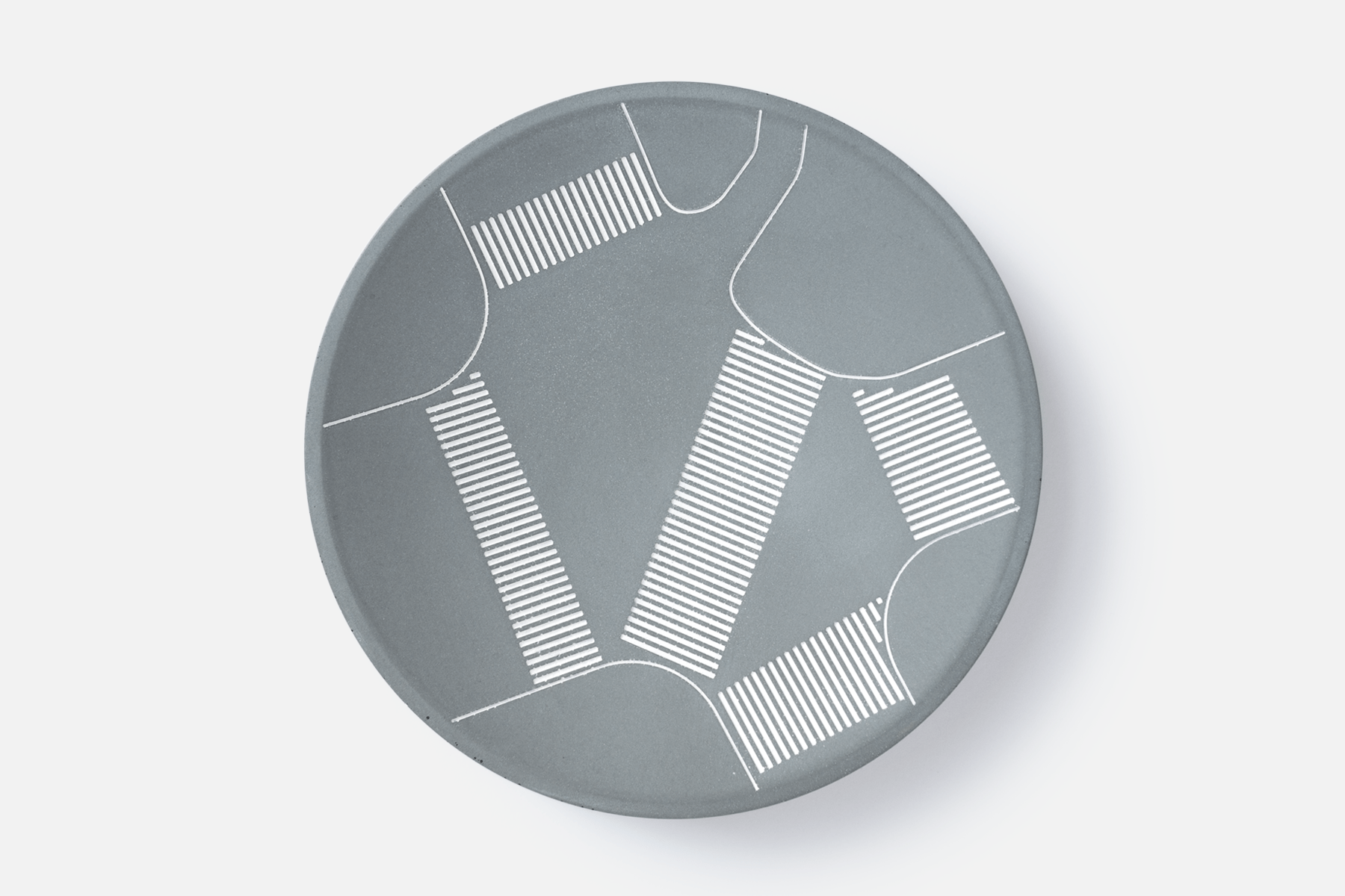 Concave tray made from fine grey concrete with markings depicting the markings of Shibuya's scramble crossing.