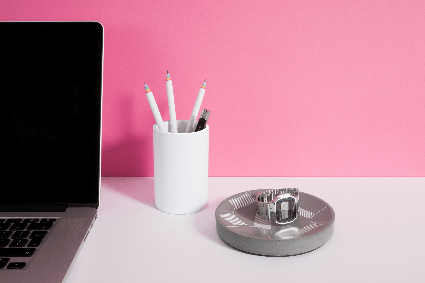 Shibuya Scramble Storage Tray shown on an office desk with a watch in it. The watch reflects on the gloss cast concrete finish.