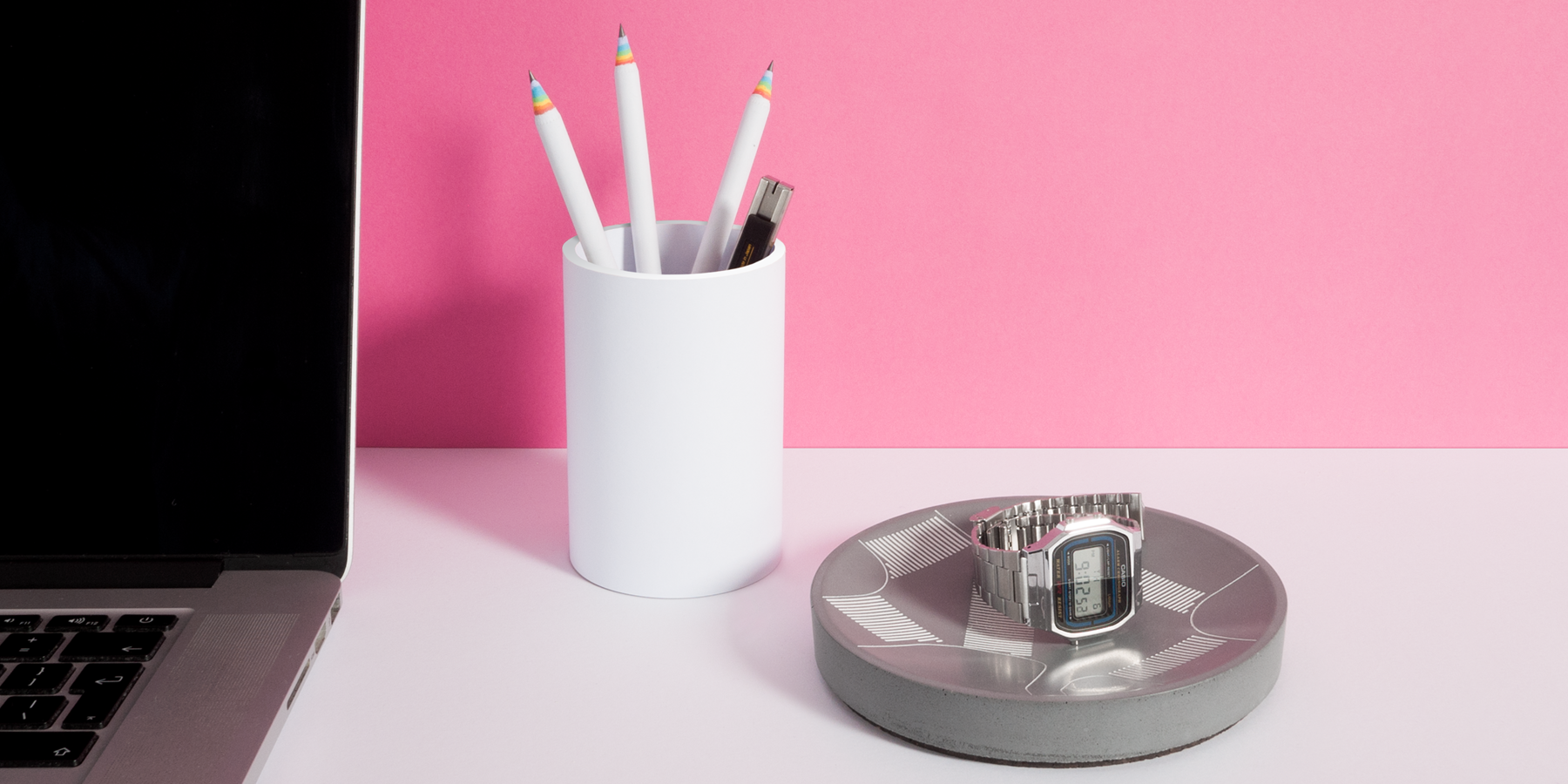 Shibuya Concrete Storage Tray shown on a desktop with a classic casio timepiece in it.