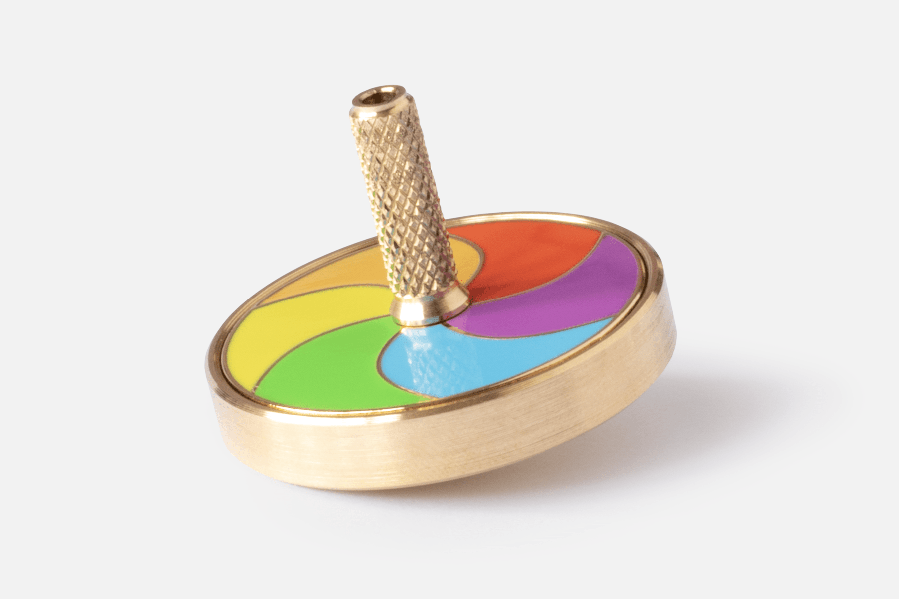 Art spinning top 'Spinning (desk)top' sat stationary and at an angle flaunting it's made in england turned brass