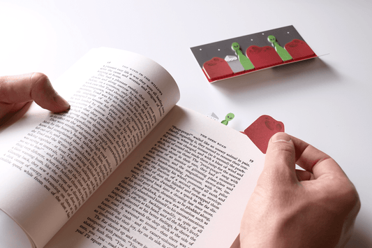 University student noting the page of a book with a mars sticky page marker