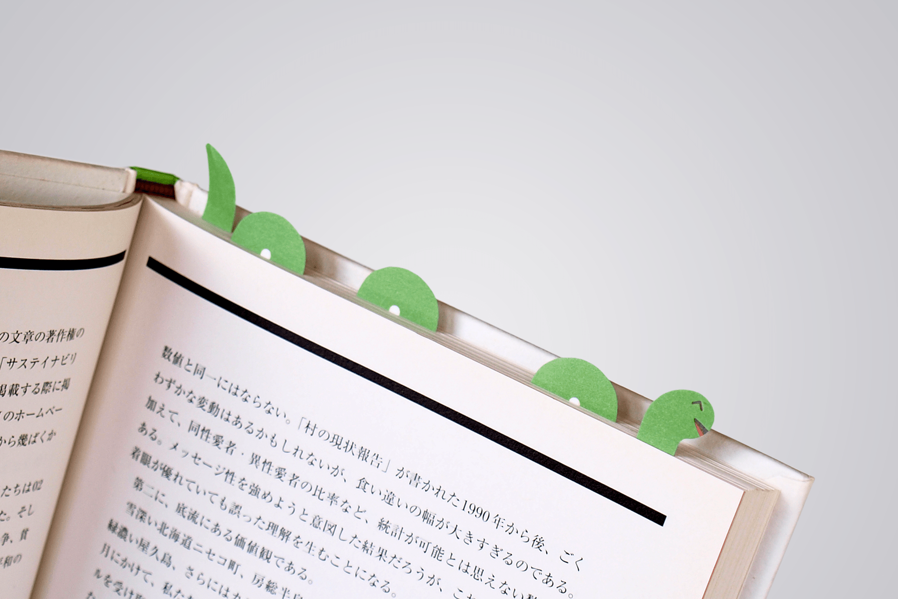 paper tab Loch ness monster weaving in and out of the pages of a book