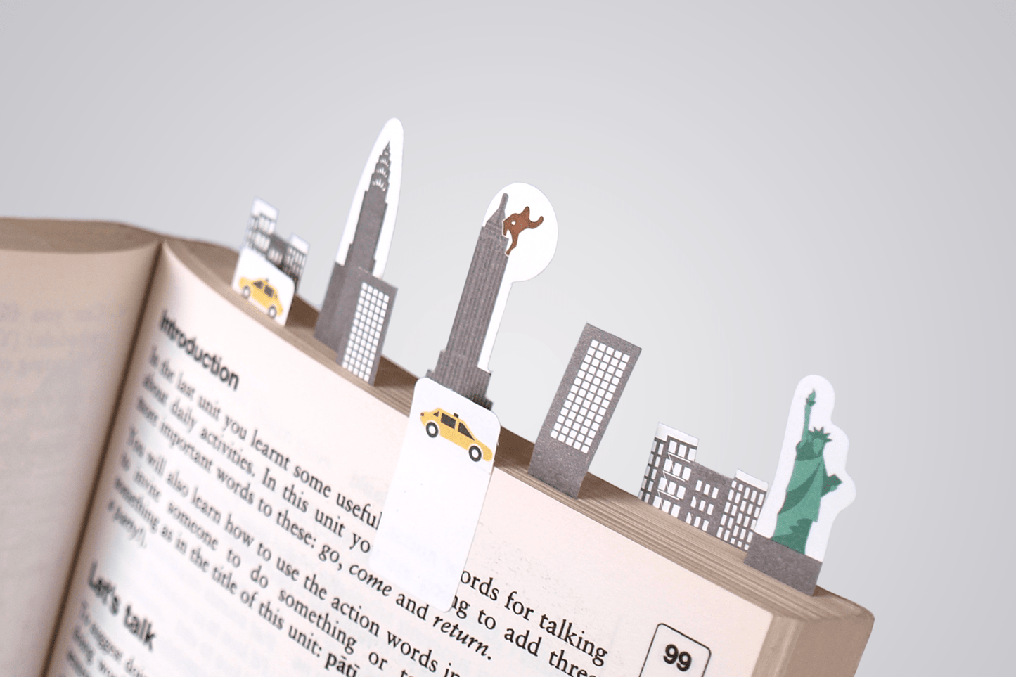 Book filled with paper tabs representing iconing features of New York city skyline
