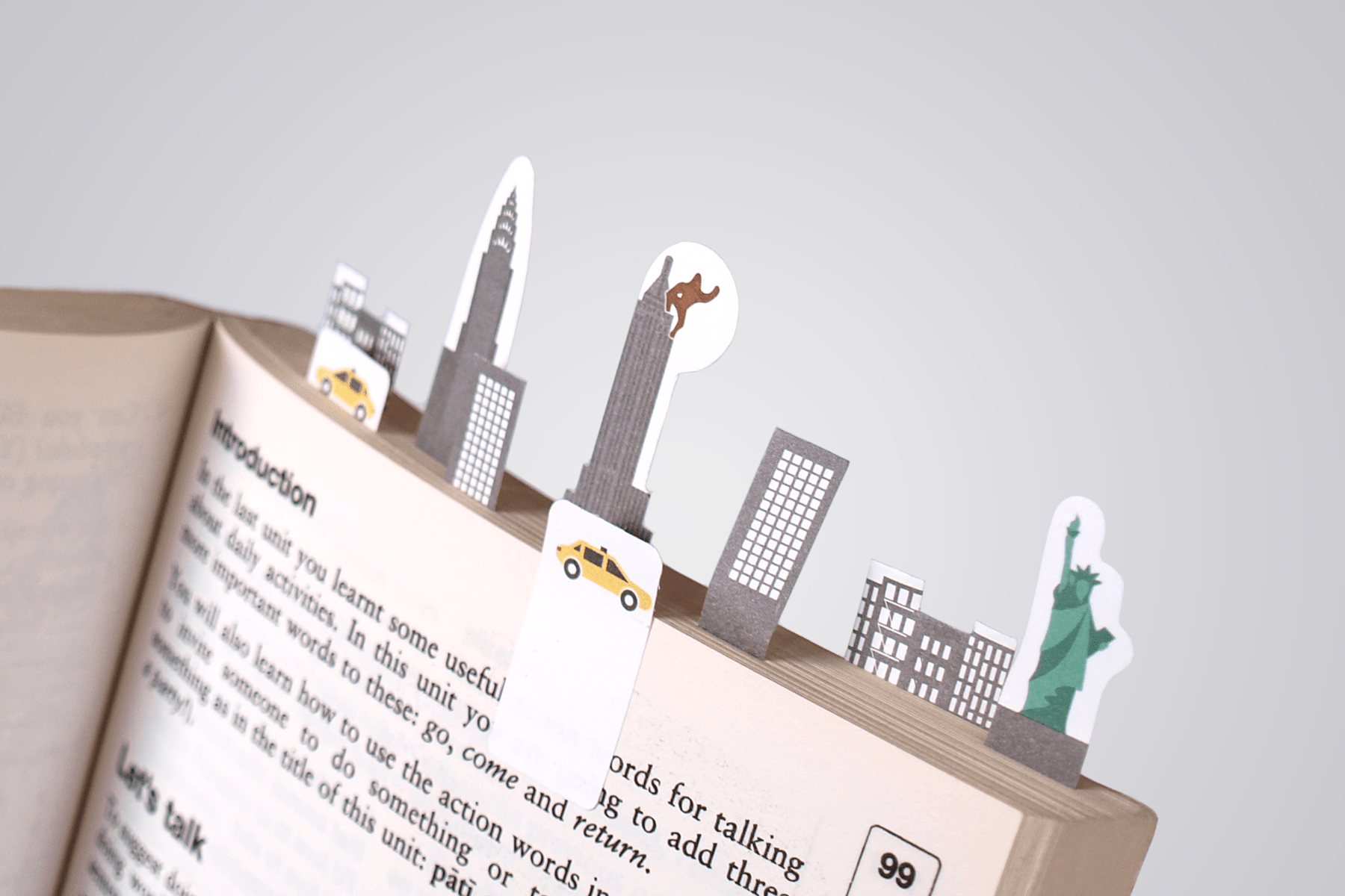 Book filled with paper tabs representing iconing features of New York city skyline