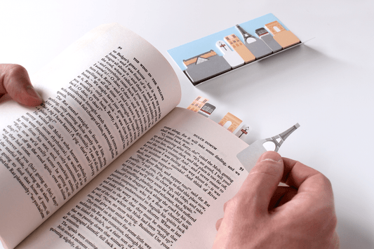 Paper tabs of buildings from Paris' Skyline being stuck into a book