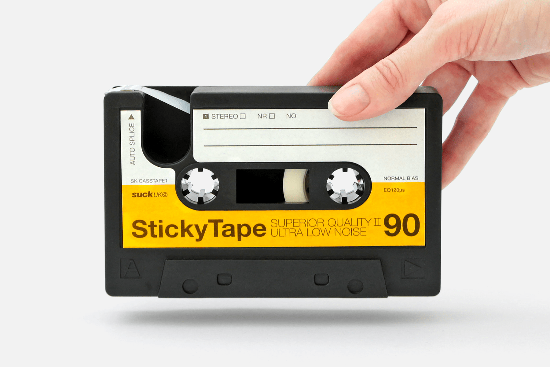 close up of hand holding sticky tape casette dispenser with cutter pointing away