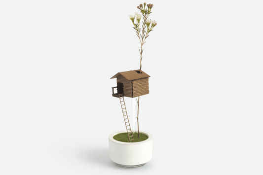 Treehouse Vase by Duncan Shotton at his Creative Design Studio with a single flower sprig. Creating the illusion the treehouse is attached to the flower.