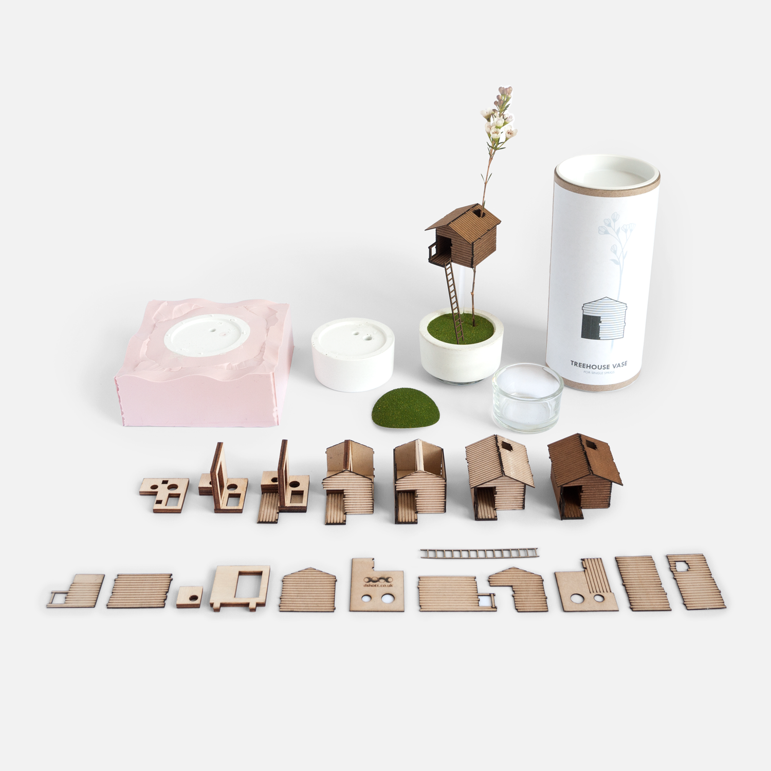 a Treehouse Vase with it's component parts laid out neatly around it, including the silicon mold used to case it's base in jesmonite