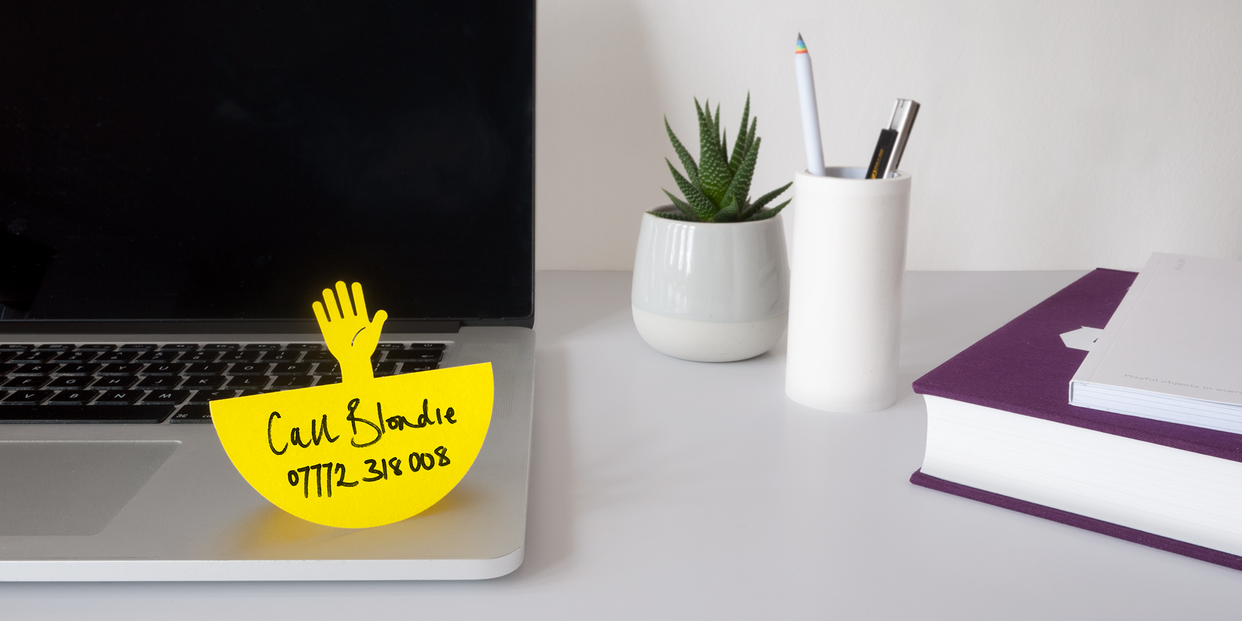 stand up paper note on laptop of office desk reminding a colleague to call someone back