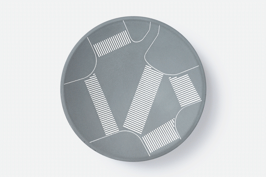 Concave tray made from fine grey concrete with markings depicting the markings of Shibuya's scramble crossing. Animation shows the tray holding a set of house keys, then the tray empty, or a loop. 