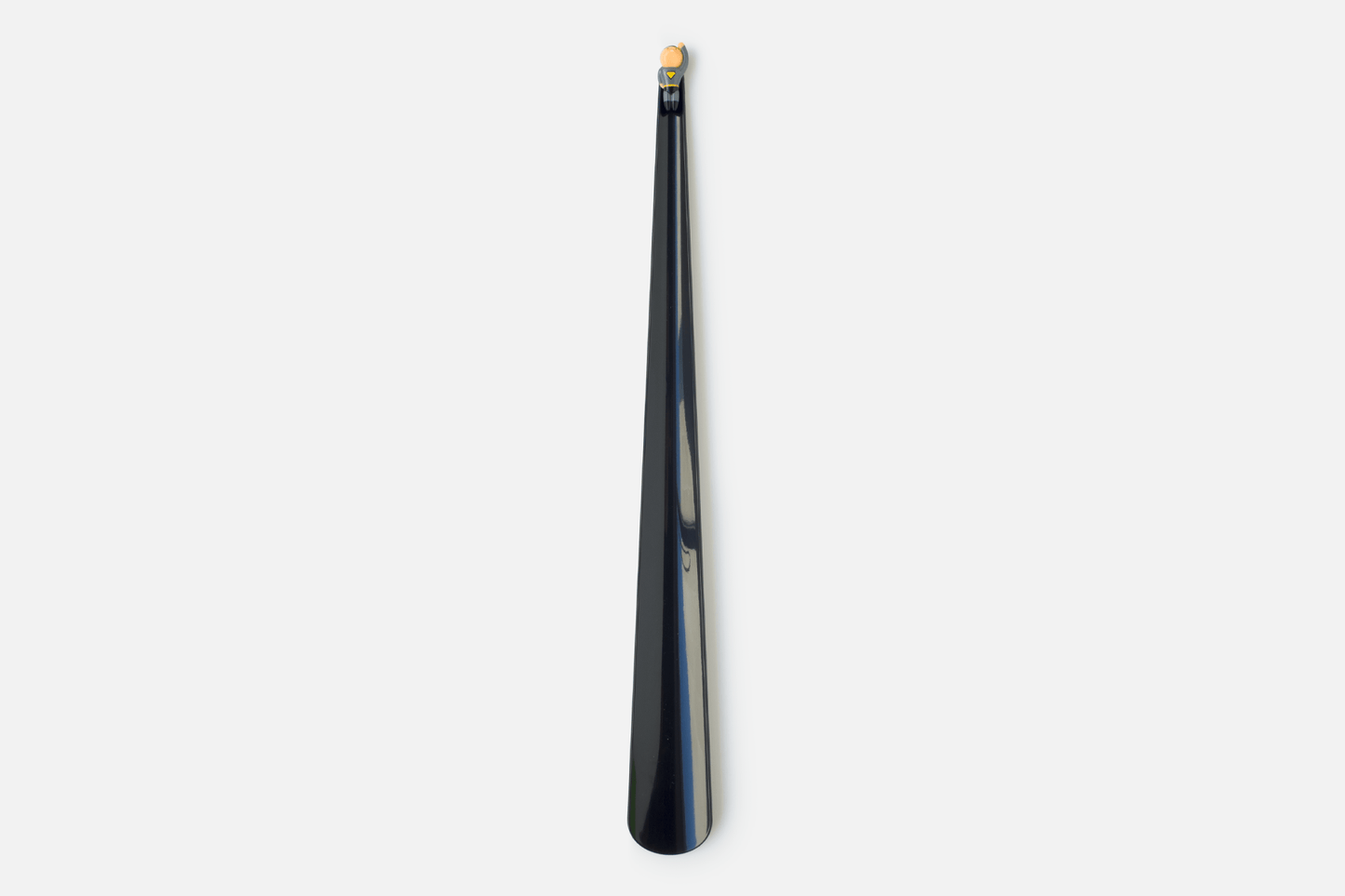 A long gloss black cape forms the functional part of the shoehorn design, whilst a minature superhero is affixed to the top to add wit and delight to the user experience
