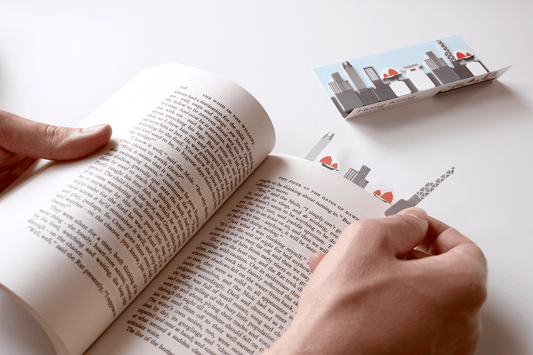 paper sticky tab of a Hong Kong building being placed inside a novel