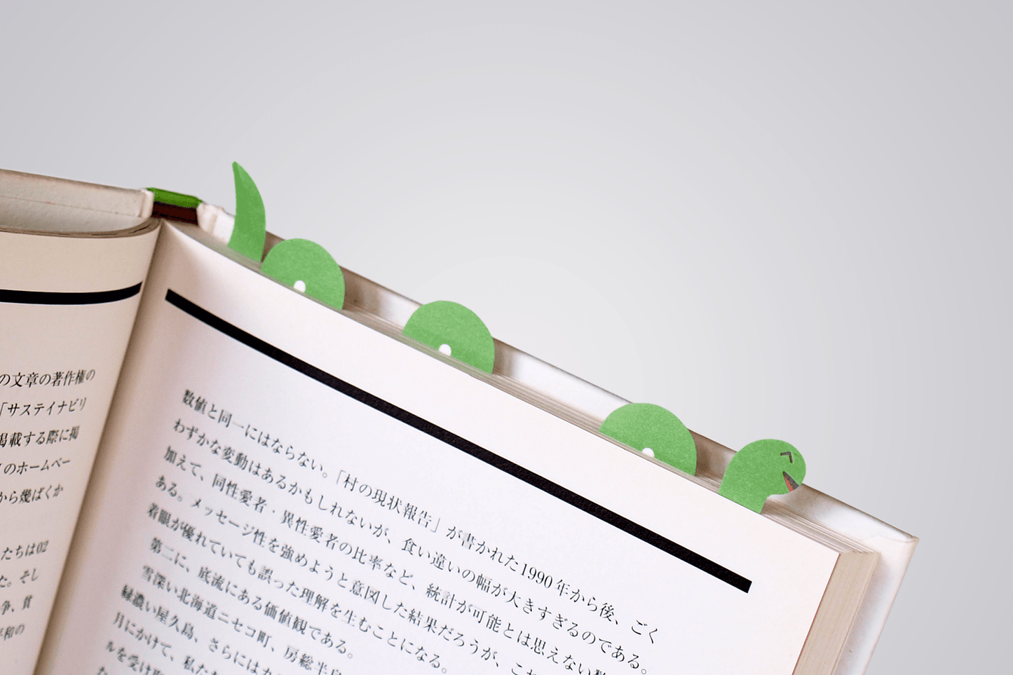 paper tab Loch ness monster weaving in and out of the pages of a book