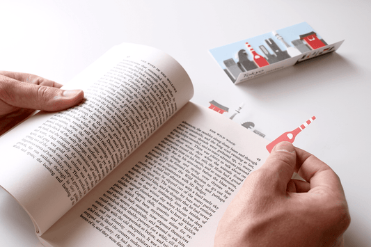 Tokyo Sticky Page Markers being used by a reader to mark the page of their book